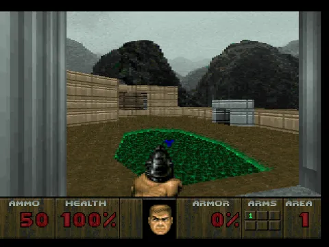 Doom: An outdoor courtyard on E1M1 with a green-floored pit; ammo 50, health 100%